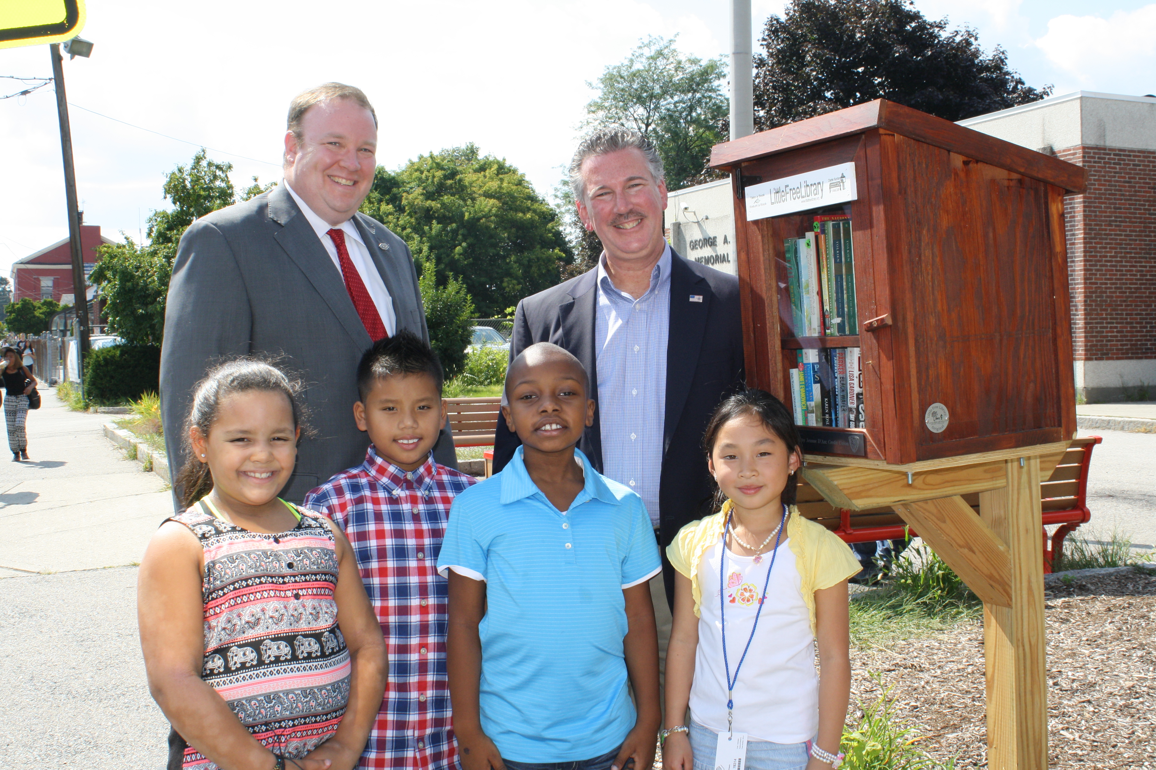 Children in front of Little Free Library in Lowell