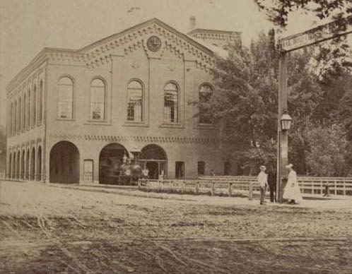 Historic photo of train station and speaking hall