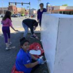 People painting a wooden structure