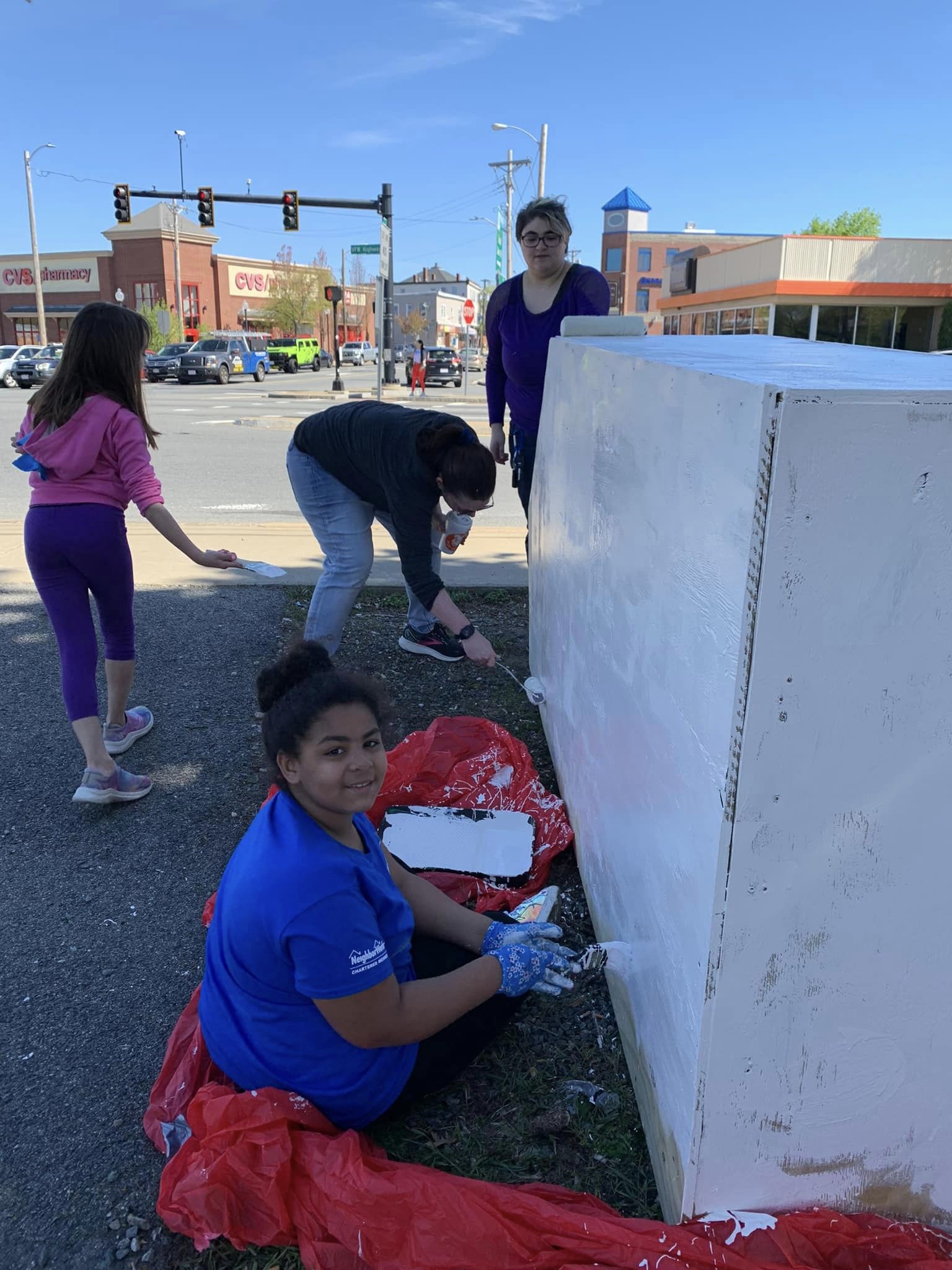 People painting a wooden structure