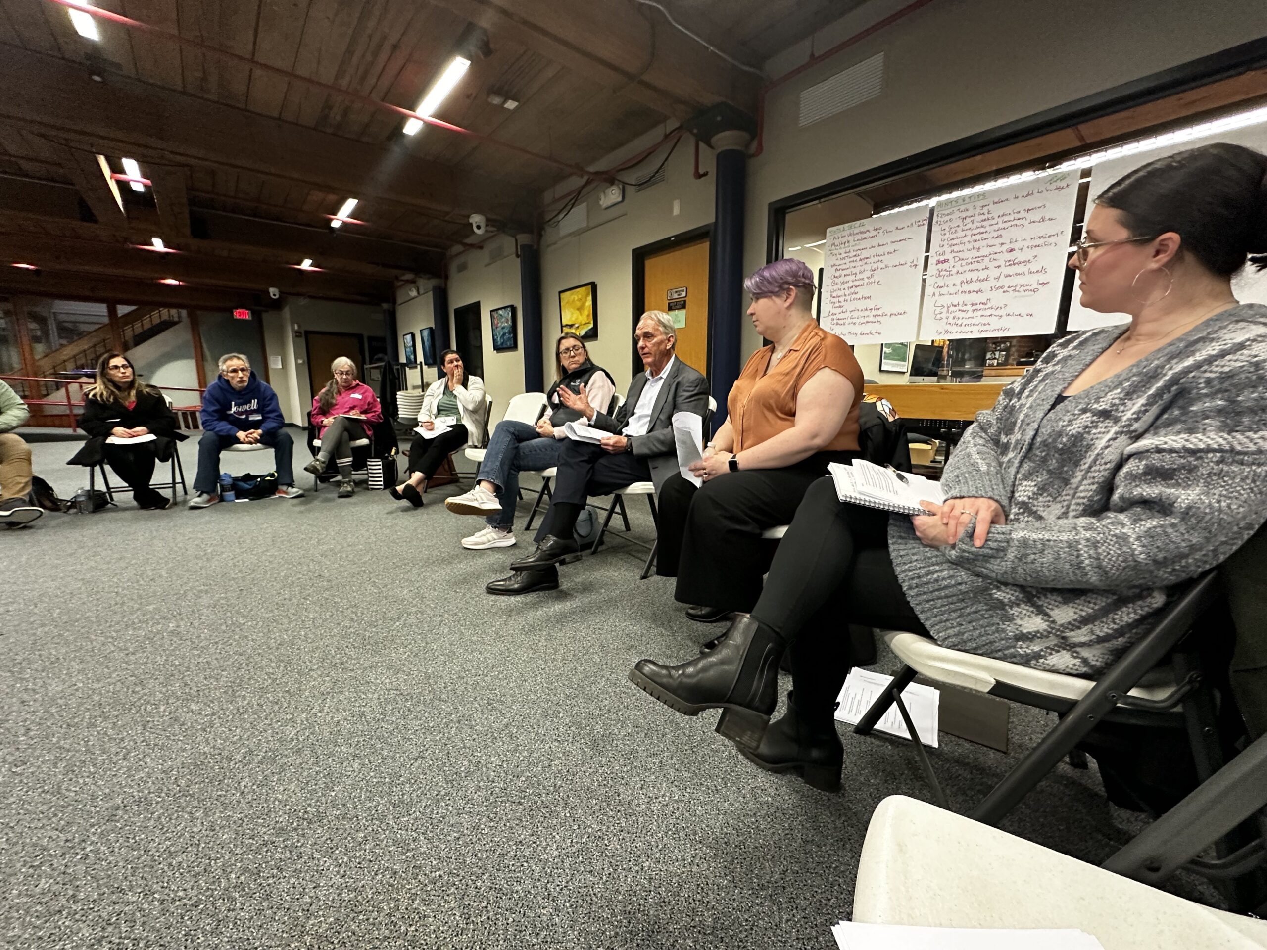 People sitting in a circle for festival and resource group.